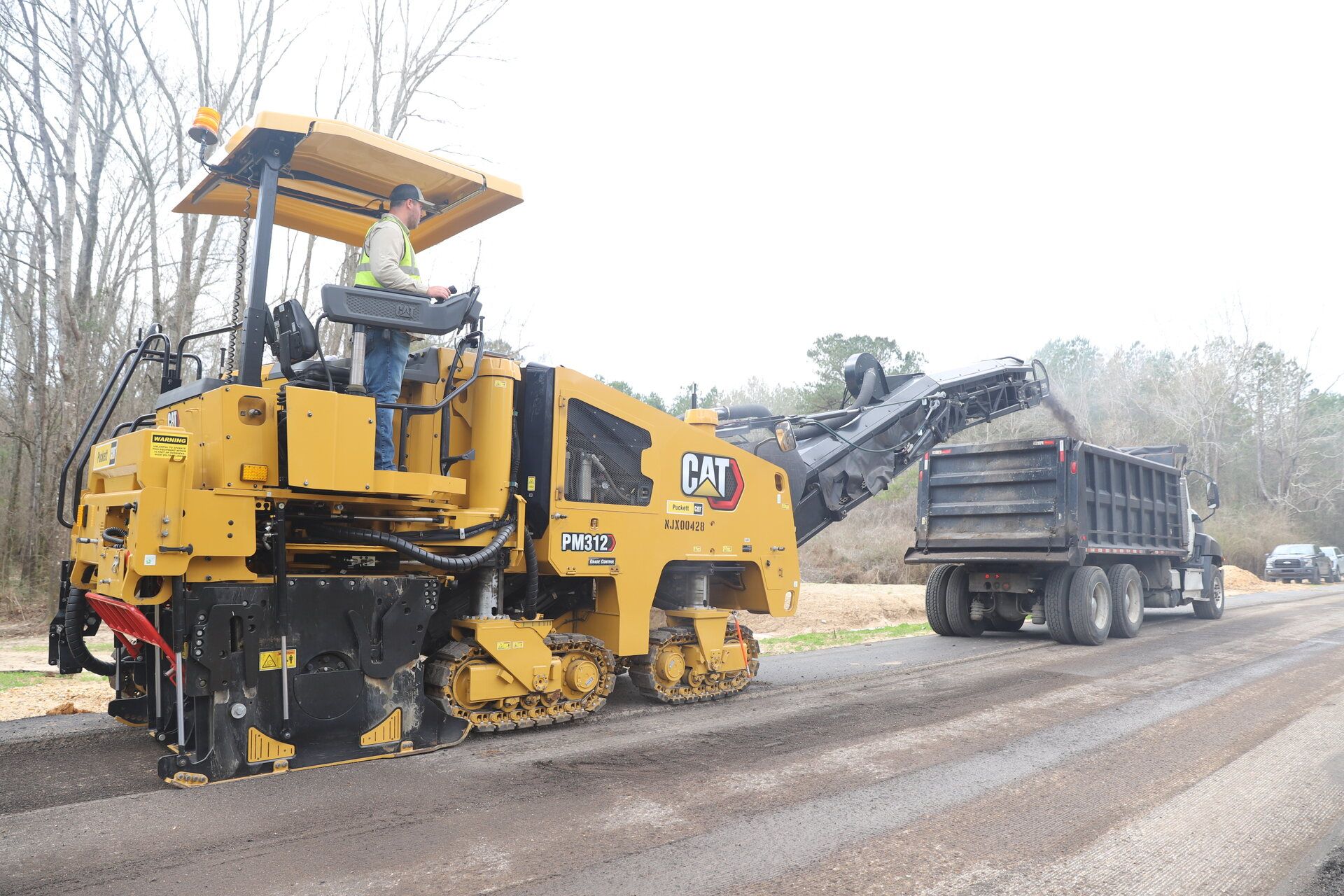 AAA Asphalt Paving crew operating an asphalt paving machine in Central Mississippi