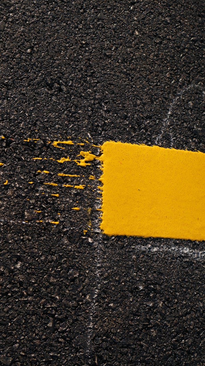 Fresh yellow road marking on a newly paved asphalt surface in Mississippi